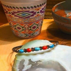 Sterling silver cuff with turquoise stones and red coral.